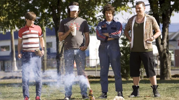 Still from Hot Rod. Jorma Taccone, Bill Hader, Andy Samberg and Danny McBride are standing in the middle of a grassy area watching a firework sparkling on the ground.