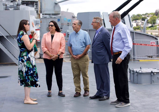 LG and Fall River elected officials aboard battleship.