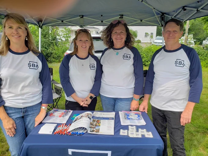 Staff at information table at booth
