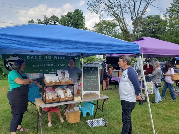Staff visiting vendor at farmers market