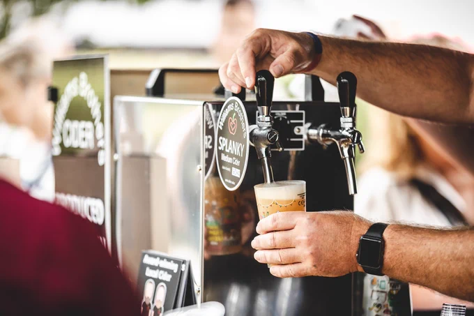 A hand pulling a pint 