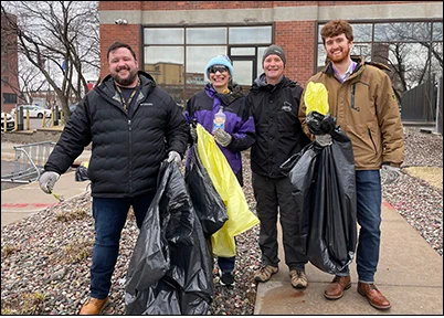 DLI staff holding garbage bags during the Earth Day cleanup