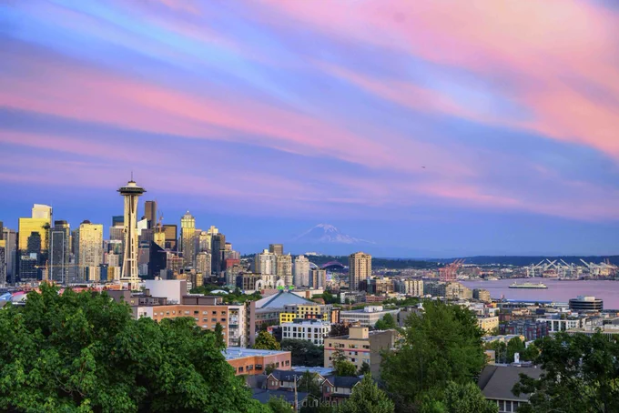 A photo of Seattle and mount rainier at sunset