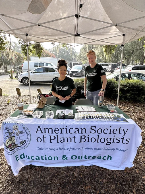 Two smiling volunteers posed for a photo behind the ASPB table