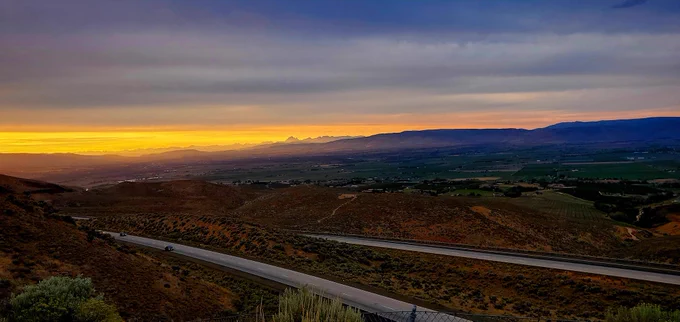 Landscape photo overlooking interstate 82 through the cascade foothills in eastern Washington at sunset