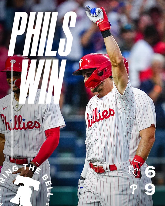 Phils win! Final Score graphic: Royals 6, Phillies 9. The photo is of Trea Turner pointing up and celebrating his home run. He’s wearing the red pinstripes uniform. 