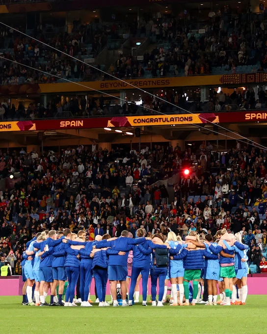 England's players and staff huddle after the FIFA Women's World Cup final.