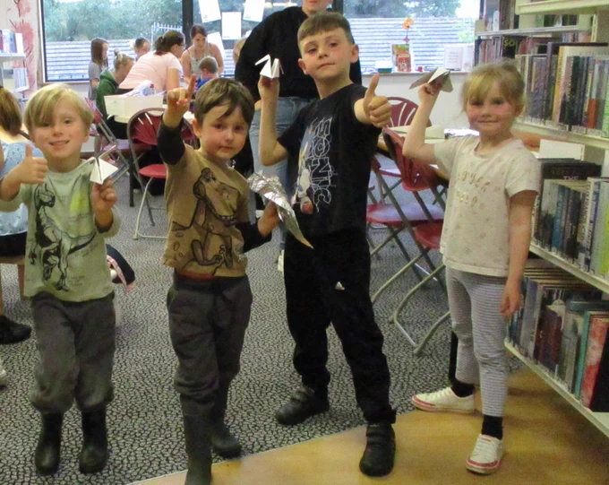 children with paper rockets