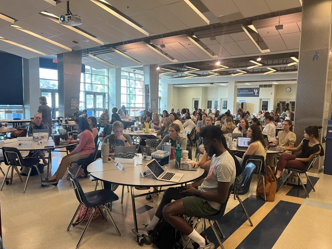 Crowd of people sitting in a cafeteria