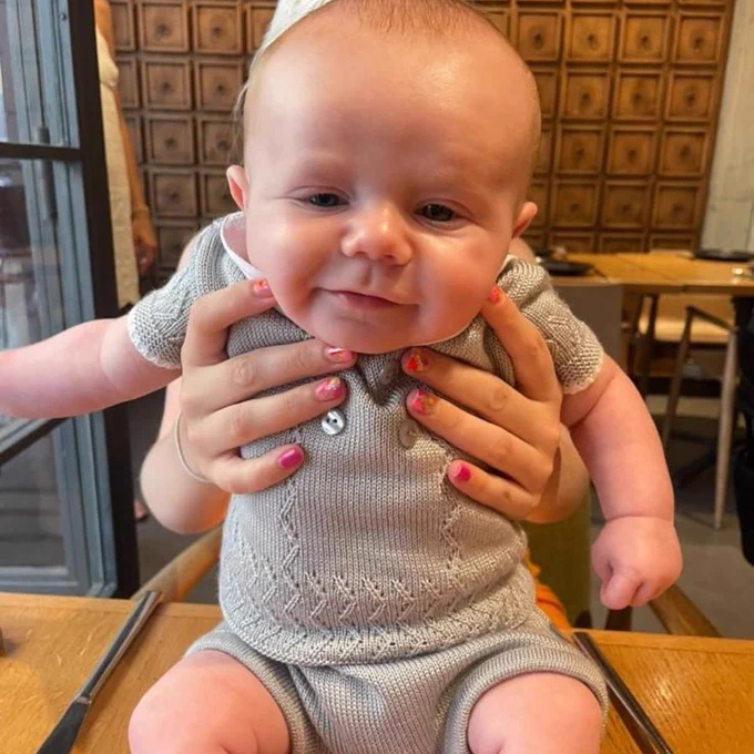 Baby Francis looking to camera and smiling