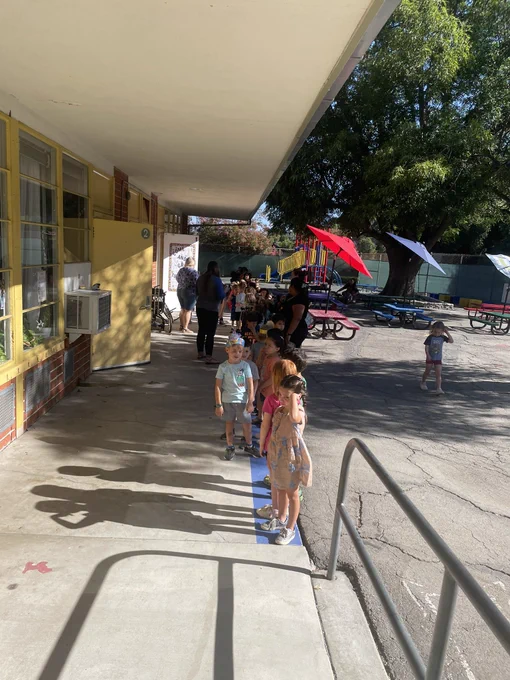 Four year old children lining up in the morning preparing@for their transitional kindergarten class.