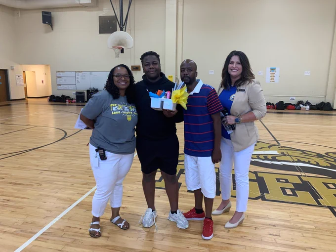 Pictured L-R: Herschel Jones Middle Principal Kimberly Silas, student Tommie Davis, Mr. Davis and PCSD Chief Academic Officer Tiffany Frachiseur.