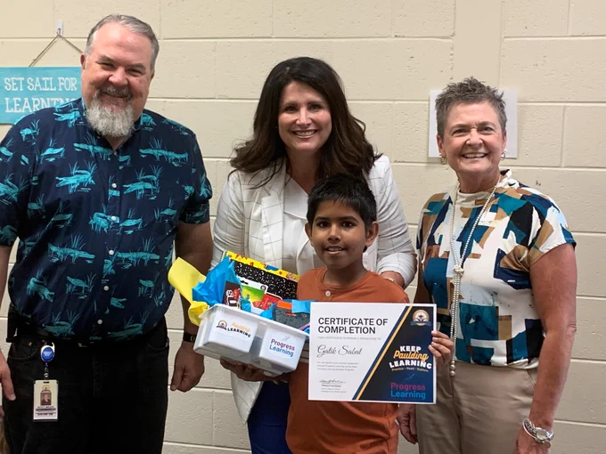 Pictured with student Gatik Sabat L-R: Abney Elementary Principal Scott Brock, PCSD Chief Academic Officer Tiffany Frachiseur and Executive Director of Elementary Curriculum Theresa Benefield.