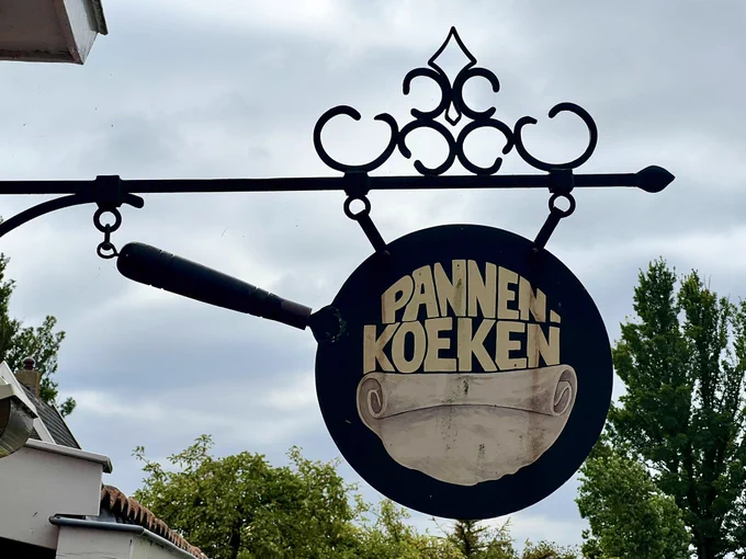 A photo of a vintage sign for Pannenkoeken taken outside of a pancake restaurant in the northern Dutch coastal town of Hindeloopen.