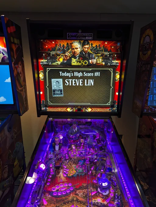 Front facing shot of Jersey Jack's The Godfather Limited Edition pinball. On the screen there is a tiny black and white mugshot of me and it reads "Today's High Score #1 Steve Lin"
