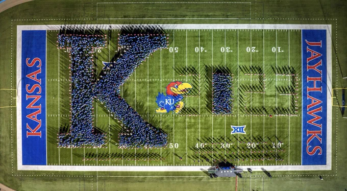 The latest incoming class of Jayhawks stands on KU's football field in a formation that reads K 2023.