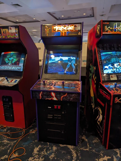 A Primal Rage 2 cabinet that looks similar to a Midway-style 2 player upright with PR2 artwork. 