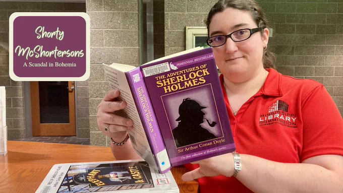 Beth, a white woman wearing glasses and a red MLC polo, holds up a copy of 'The Adventures of Sherlock Holmes' by Sir Arthur Conan Doyle. In the corner of the graphic are the words 'Shorty McShortersons: A Scandal in Bohemia.'
