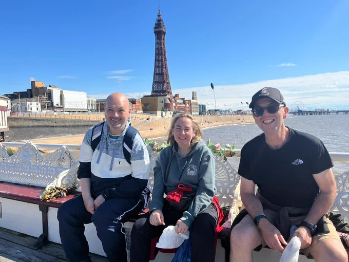 3 people in Blackpool with tower in background