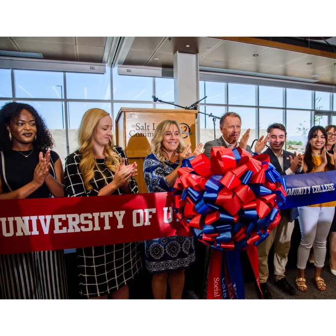 Smiling students and administrators celebrate the ribbon joining ceremony for the new Juniper Building at the Herriman Campus. 