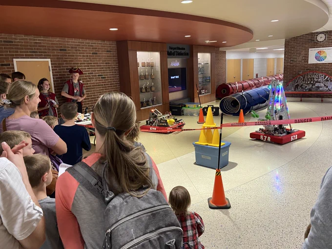 Fairport families watch a robotics competition at the Summer Fun Night!