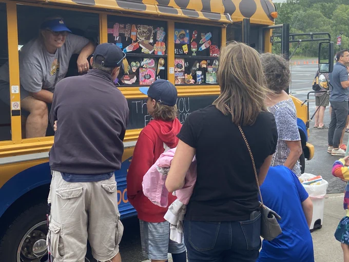 Food trucks were outside the event. This picture shows a family getting ice cream. 
