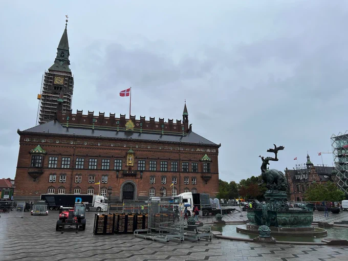 Copenhagen City Hall and the Square in front with several vehicles and trailers with infrastructure to build Copenhagen Pride Square. 