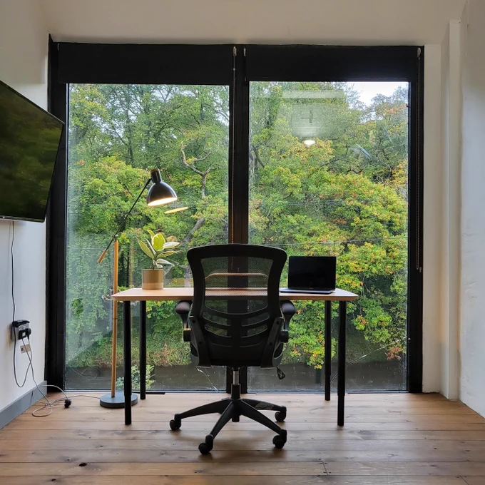 Desk positioned next to a large window.