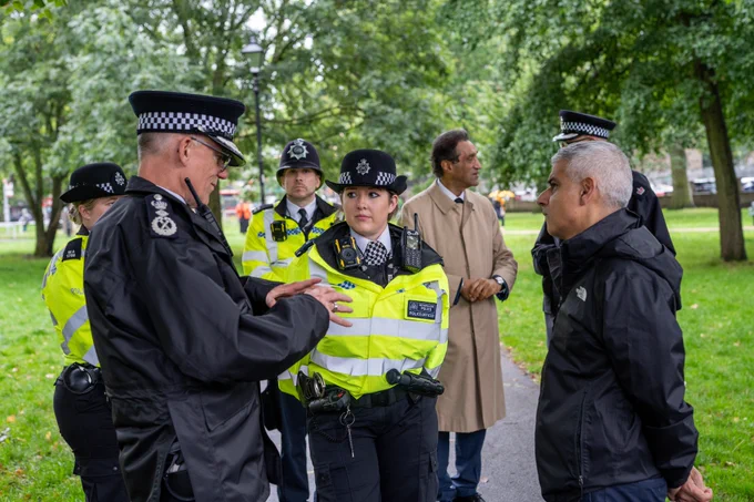 Sir Mark Rowley and the Mayor of London speaking to a police officer in Ealing