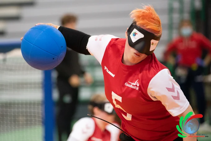 Action shot of Meme about to shoot with red kit on during the World Championships