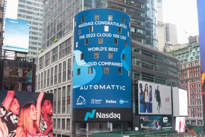 Image shows a digital billboard in Times square, where Nasdaq is congratulating Automattic as one of the world's best cloud companies on the 2023 Cloud 100 list.
