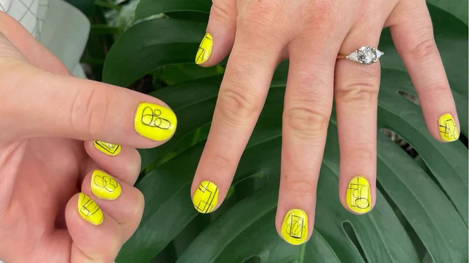 two white hands with neon yellow nail polish and figma logos in black sketch
