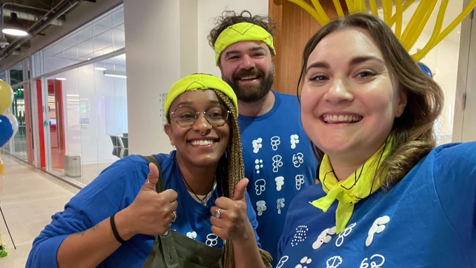 three people smiling at camera in Maker Week tshirts and yellow bandanas