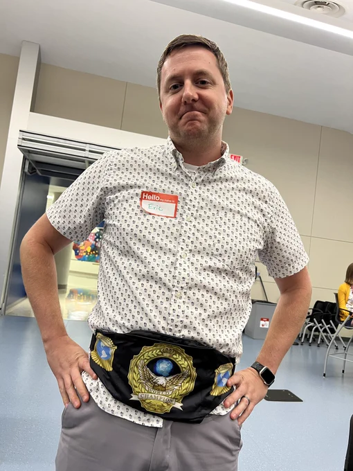 Man with wrestling champion belt around his waist.