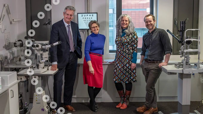 Two men and two women, all smiling, standing in an optical practice room