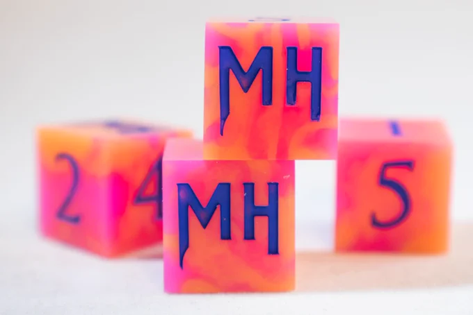 Swirling orange and magenta dice with dark blue numbering. Instead of a 6, there is an MH logo.