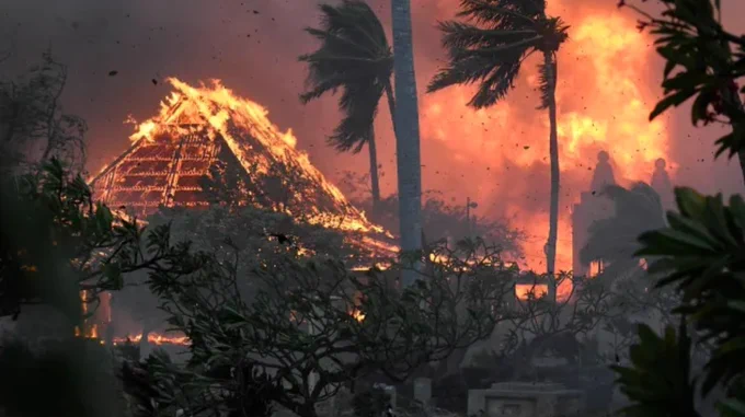 The hall of historic Waiola Church in Lahaina and nearby Lahaina Hongwanji Mission are engulfed in flames along Wainee Street on, Aug. 8, in Lahaina, Hawaii. (Matthew Thayer/The Maui News via AP)