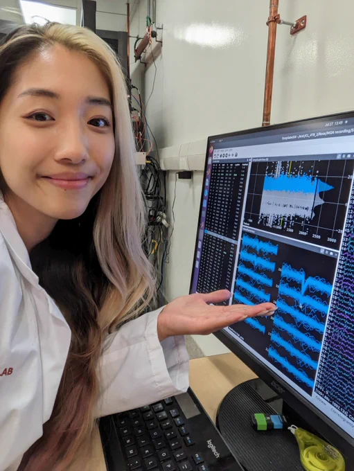 Rose Ying in the lab gesturing toward a computer screen