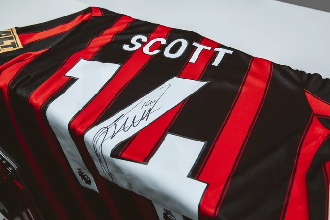 An AFC Bournemouth shirt signed by Alex Scott.