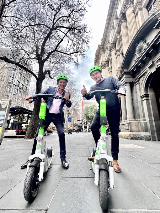 Acting Lord Mayor Nicholas Reece and Councillor Davydd Griffiths ride Lime e-scooters outside the Town Hall. 