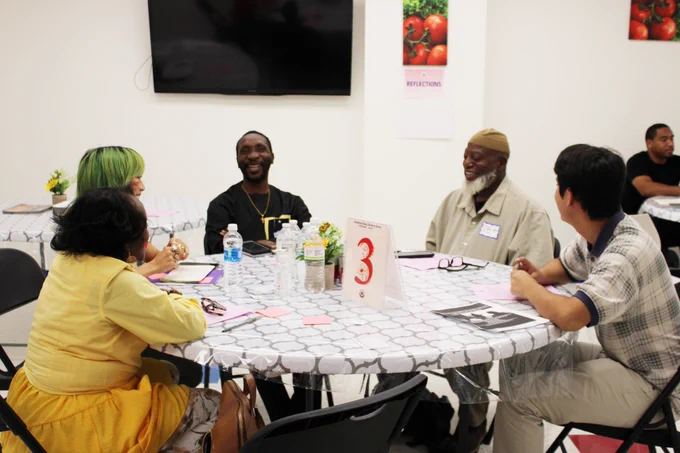 A photo of participants sitting around a table.