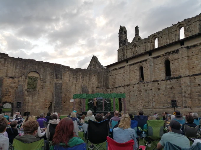 Audience looking at the stage in Kirkstall Abbey