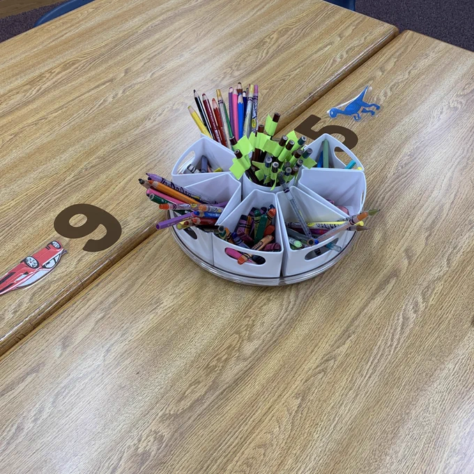 Lazy Susan with supplies on a table with numbers and shapes.