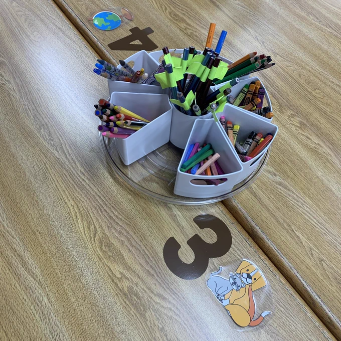 Lazy Susan with supplies on a numbered table.