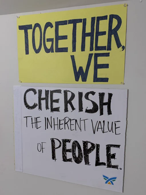 Sign depicting the phrase, “Together, We Cherish the Inherent Value of People.”