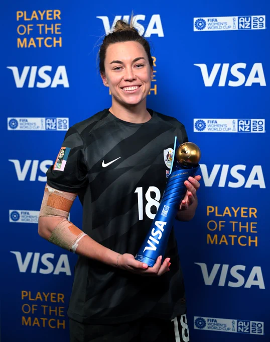 Mackenzie Arnold holding the player of the match trophy.