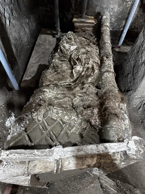 The plaster cast of the bed with the posts and rope netting that make the bed frame and the imprint of the folds and form of the blanket left messily on top of it