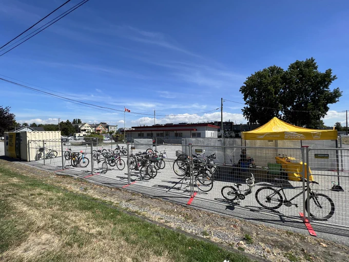 Dozens of bikes parked on racks within the valet