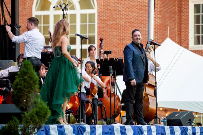Colin Ruffer, right, looks over at Tiffany Haas, left while performing on stage with the Virginia Symphony Orchestra.