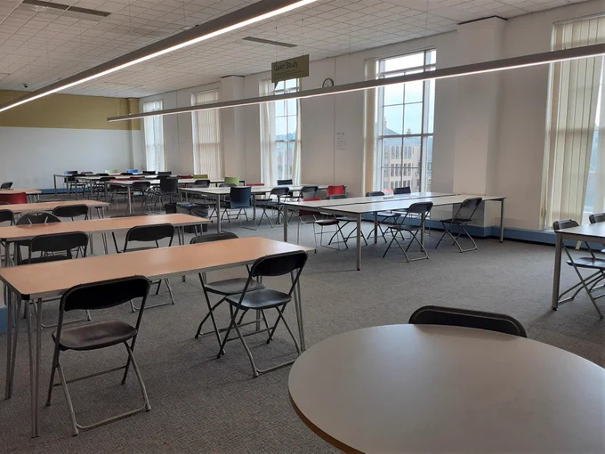 large room filled with desks and chairs